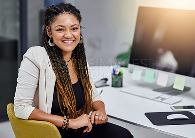 Buy stock photo Cropped portrait of an attractive young businesswoman sitting at her desk in the office