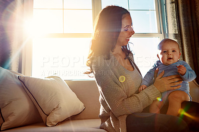 Buy stock photo Mother, holding and infant on sofa in living room with love for relationship with new born, care and embrace. Light, smile and relax with baby or child, happiness and playing on couch in home.