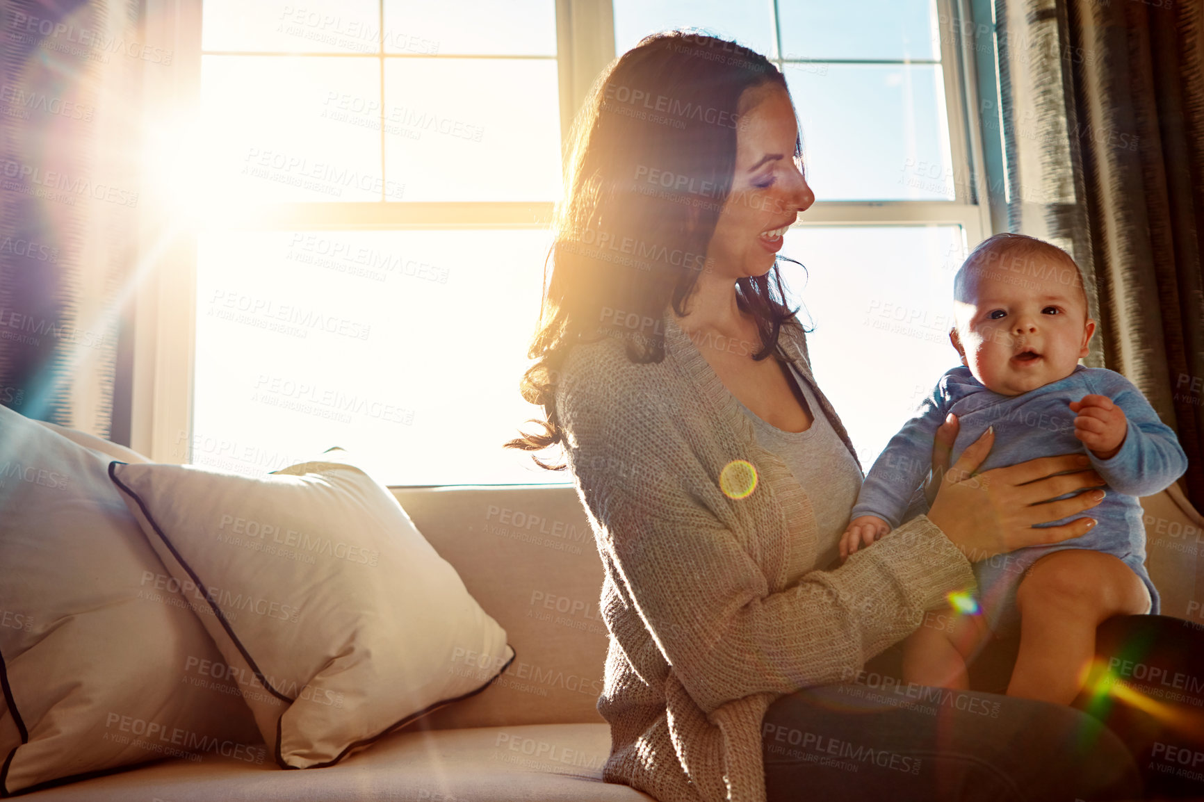 Buy stock photo Mother, holding and infant on sofa in living room with love for relationship with new born, care and embrace. Light, smile and relax with baby or child, happiness and playing on couch in home.