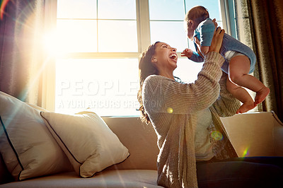 Buy stock photo Mother, infant and embrace on sofa in living room with love for relationship with new born, care and playing. Light, smile and relax with baby or child, happiness and wellness on couch in house.