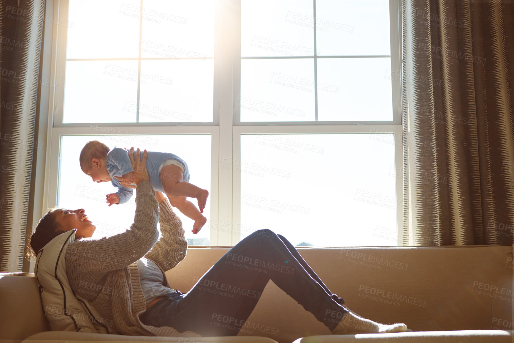 Buy stock photo Happy, mother and baby on sofa playing on weekend for love, bonding and relationship development in home. Care, woman and child together on couch in summer for safety, support in living room