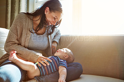 Buy stock photo Baby, mother and bonding in living room on sofa with love for relationship with new born, care and embrace. Light, sunshine and relax with smile, happiness and playing on couch with child in house.