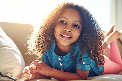 Buy stock photo Portrait of a happy little girl relaxing on the couch at home