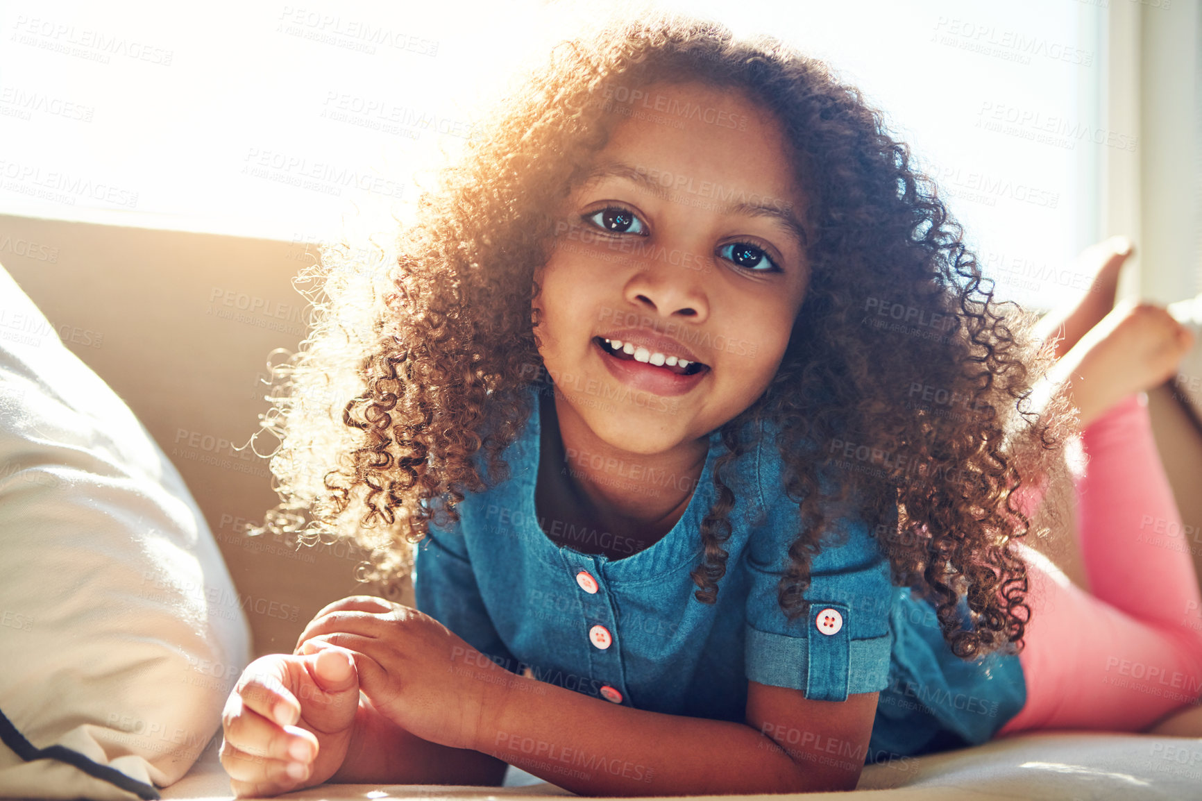 Buy stock photo Portrait of a happy little girl relaxing on the couch at home