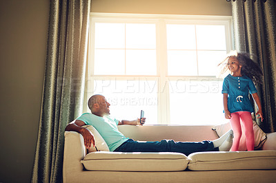 Buy stock photo Dad, phone picture and girl on couch with jumping for weekend fun together and Happy memory for social media update. Young child, papa and mobile video with playing on sofa for love bonding in home