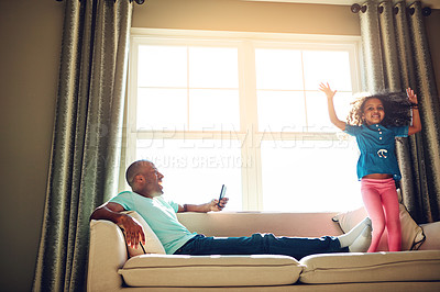 Buy stock photo Black man, phone picture and girl on couch with jumping for weekend fun together and post for social media in home. Young child, African father and mobile video with playing on sofa for love bonding