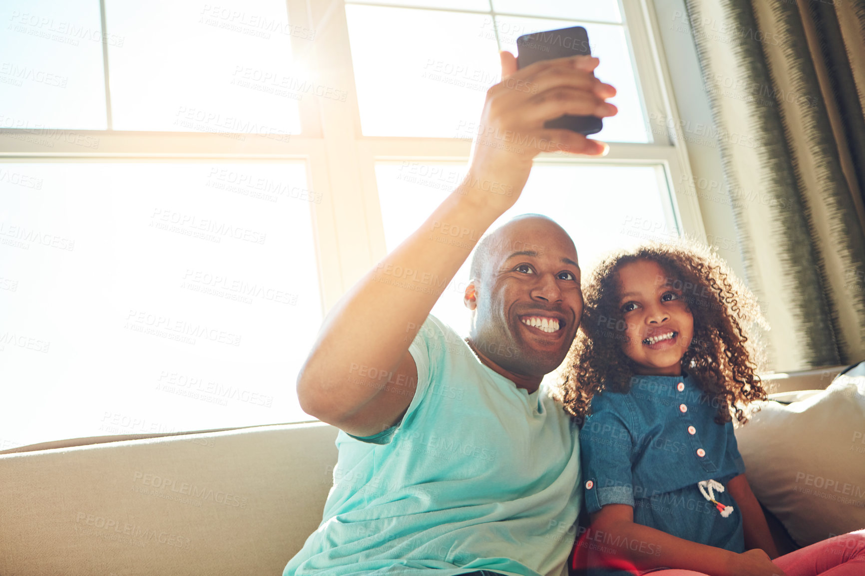 Buy stock photo Black dad, girl and happy with selfie on sofa at home for fun, bonding and care with trust. Parent, daughter and kid with smile for memories, support and child development or growth in living room