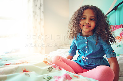 Buy stock photo Portrait of a cheerful little girl relaxing on her bed at home