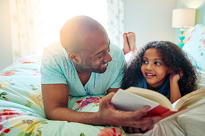 Buy stock photo Black dad, girl and smile with storytelling on bed at home for fun, bonding and care with education. Parent, daughter and kid with learning on book reading for knowledge, information and child growth