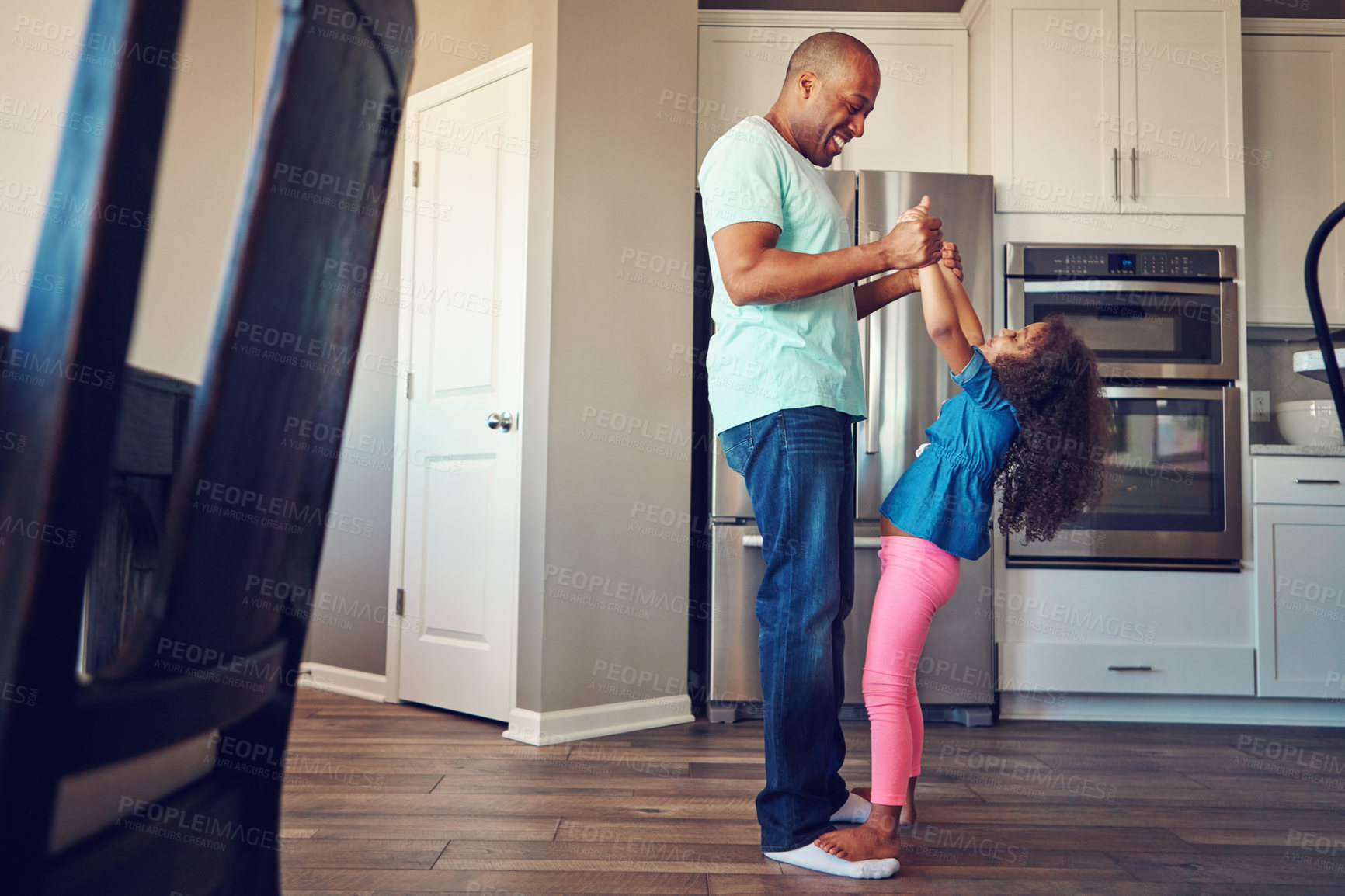 Buy stock photo Dance, weekend and father with girl in home for bonding, relationship and fun together with music. Family, parenting and happy dad with child in kitchen for relax, playing and teaching dancer move