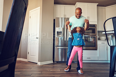 Buy stock photo Dance, black man and father with girl in home for bonding, relationship and fun together on weekend. Family, parenting and dad with child in kitchen for relax, playing and teaching move to music