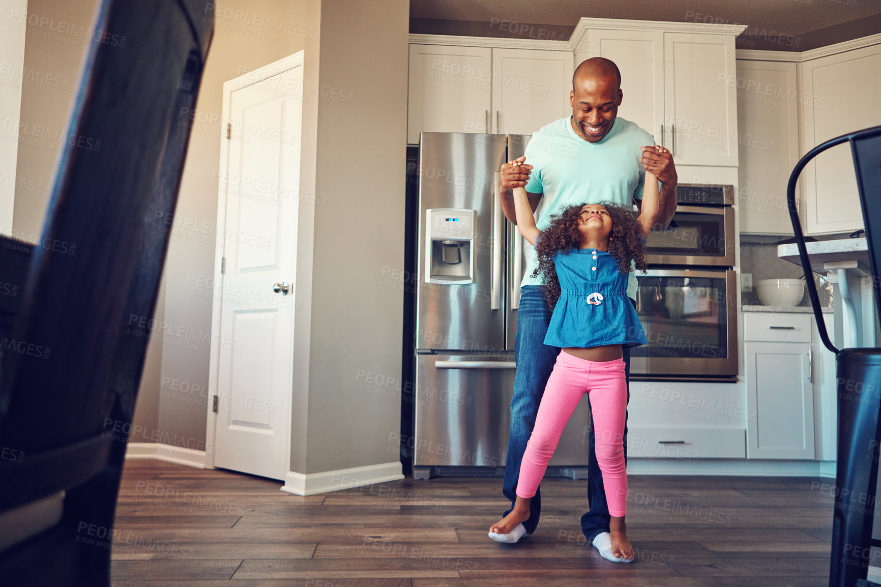 Buy stock photo Dance, black man and father with girl in home for bonding, relationship and fun together on weekend. Family, parenting and dad with child in kitchen for relax, playing and teaching move to music
