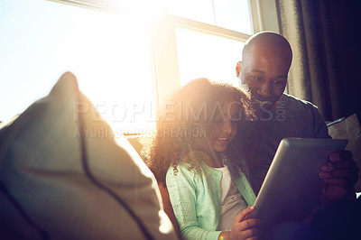 Buy stock photo Home, dad and child with tablet on sofa for game, streaming cartoon or movies in lounge. Sunshine, father and girl with digital for elearning, education or online application to read ebook on couch