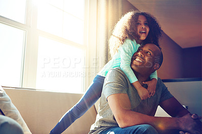 Buy stock photo Happy, dad and girl with hug on sofa in living room for support, love and gratitude on fathers day. Playful, black family and man with little kid at home for bonding, weekend and care in childhood