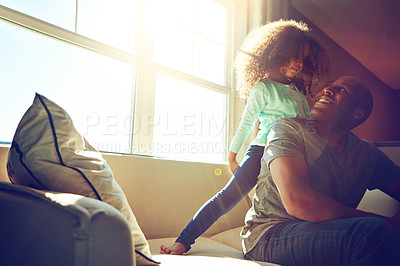 Buy stock photo Man, smile and child with playing on sofa in living room for support, care and bonding together. Black family, relax and little girl with dad at home for weekend, happiness and love on fathers day