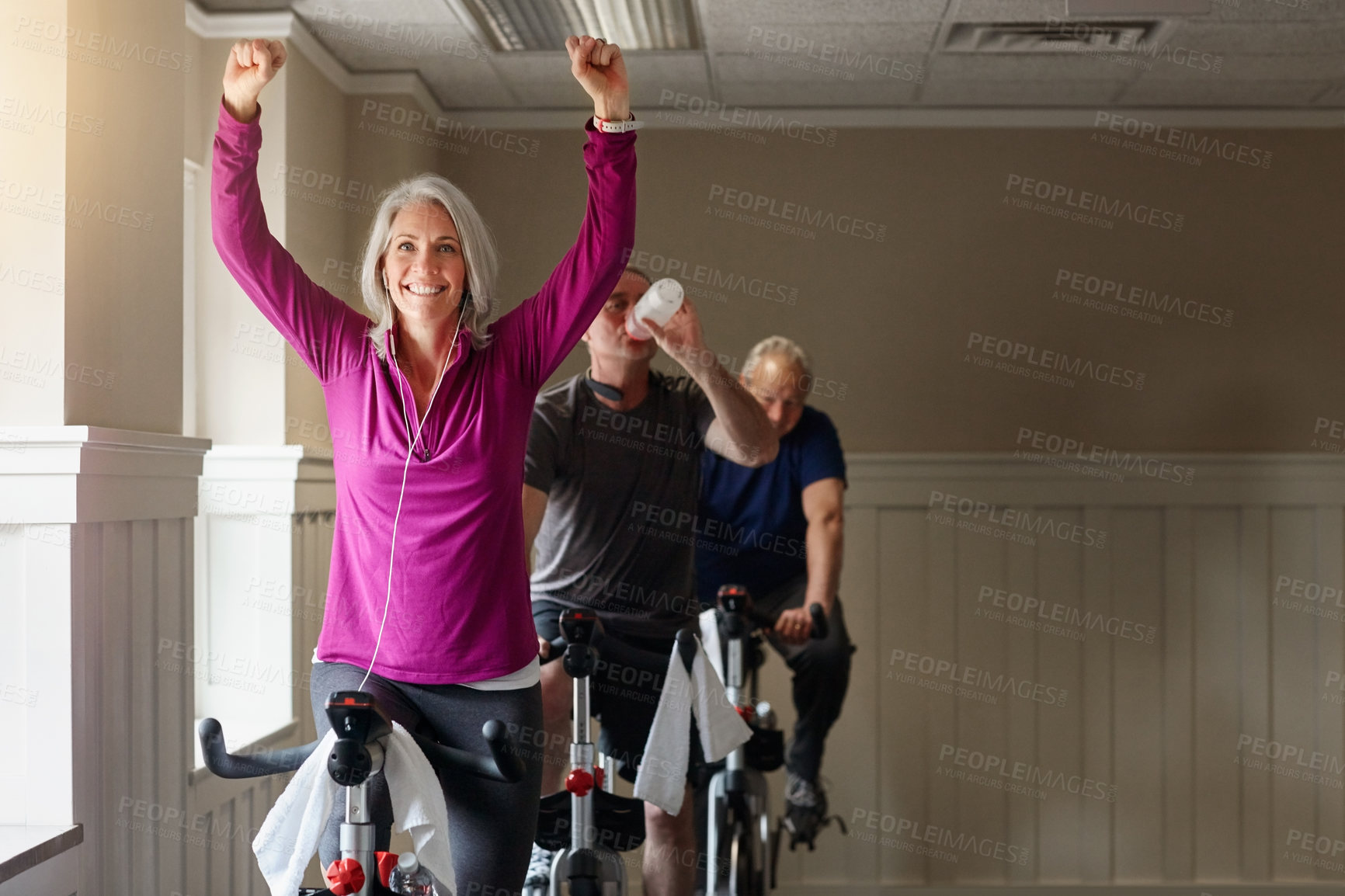 Buy stock photo Gym, winner or happy woman on cycling bike in workout or cardio training for progress, health or wellness. Class, exercise and excited senior person on bicycle machine for fitness, success and goal