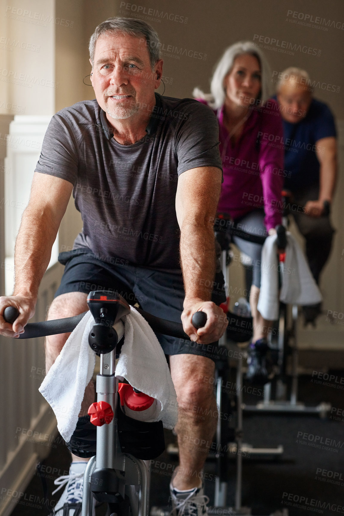 Buy stock photo Fitness, spinning class and senior man in gym for cycling, exercise and training with physical activity. Workout club, team and people on bicycle for health, wellness and endurance with cardio