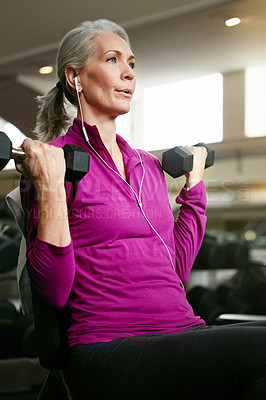 Buy stock photo Senior fitness, old woman and dumbbell at gym for training, wellness or cardio with earphones, music or mindset. Weightlifting, bodybuilding and elderly female person at sports center for arm workout