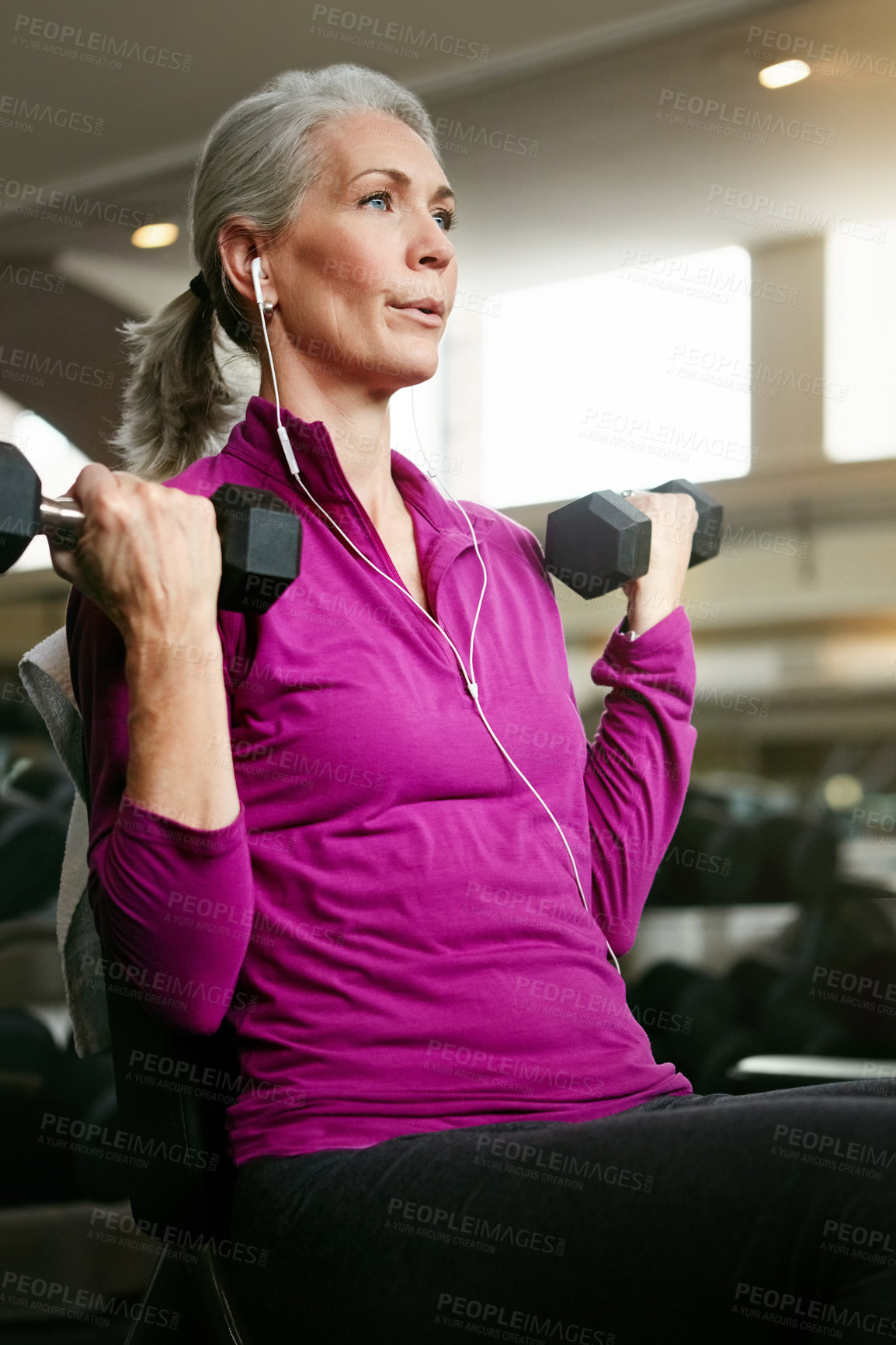 Buy stock photo Senior fitness, old woman and dumbbell at gym for training, wellness or cardio with earphones, music or mindset. Weightlifting, bodybuilding and elderly female person at sports center for arm workout