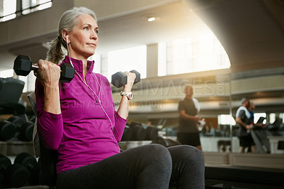 Buy stock photo Portrait of a senior woman working out with weights at the gym
