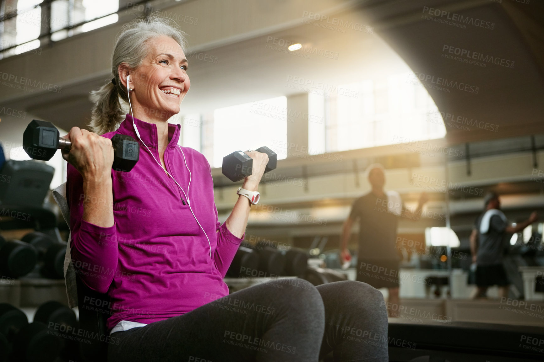 Buy stock photo Portrait of a happy senior woman working out with weights at the gym