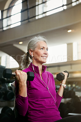 Buy stock photo Portrait of a happy senior woman working out with weights at the gym