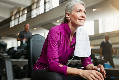 Buy stock photo Portrait of a happy senior woman taking a break from her workout at the gym