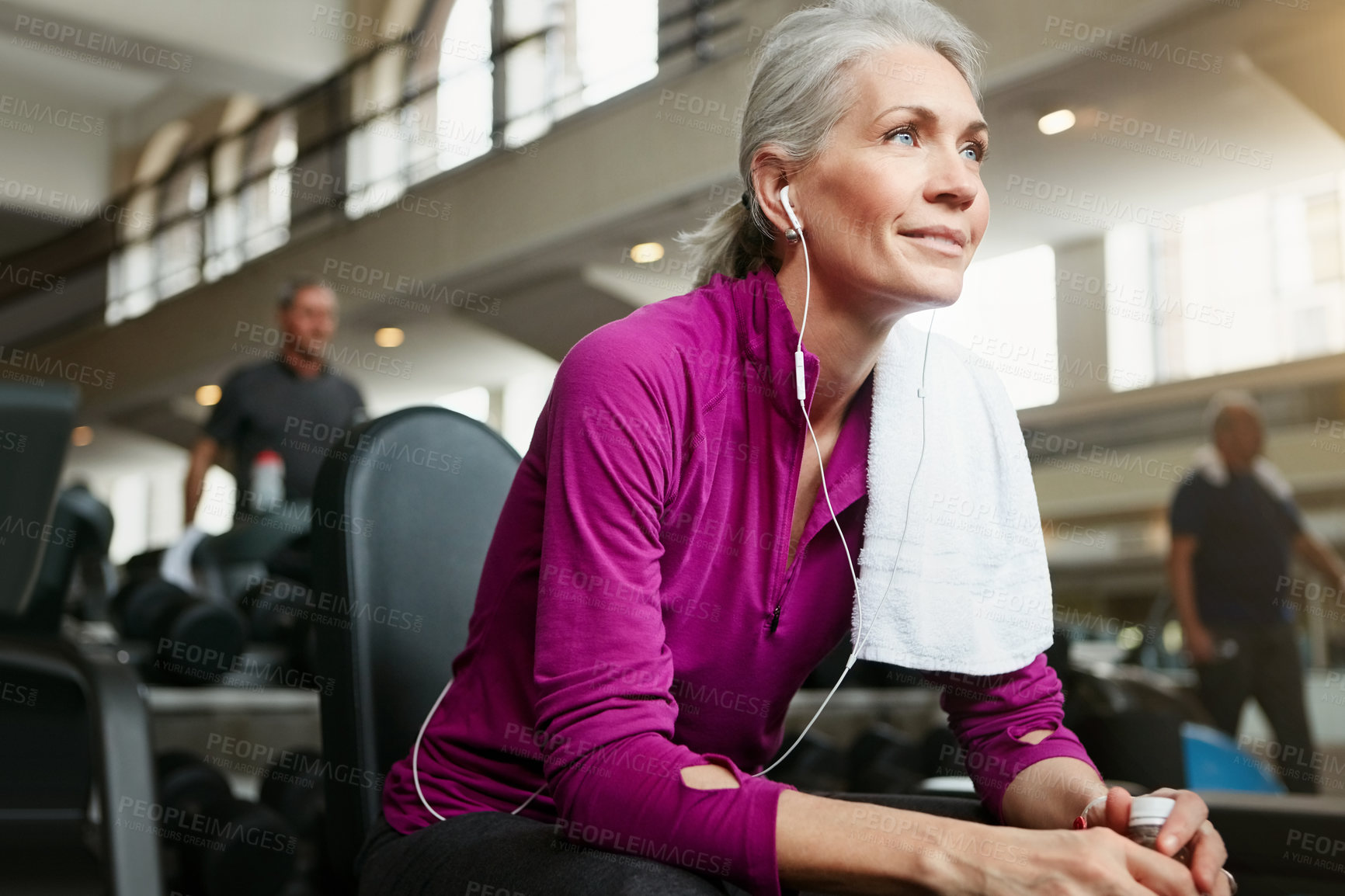 Buy stock photo Portrait of a happy senior woman taking a break from her workout at the gym