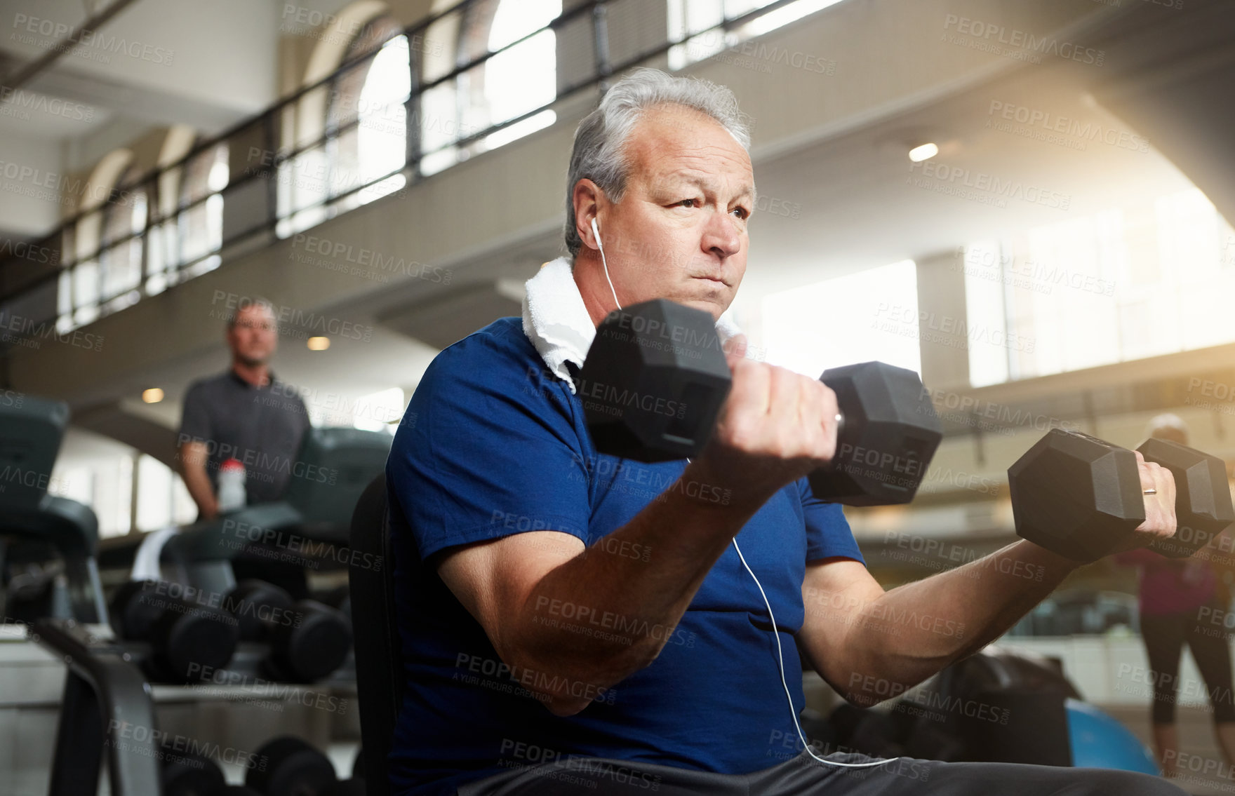 Buy stock photo Mature man, earphones and weightlifting with dumbbells for workout, training or indoor exercise at gym. Male person with small weight for strength, muscle gain or power in fitness at health club