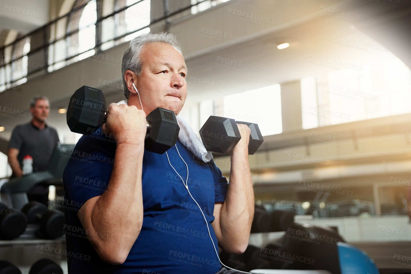 Buy stock photo Shot of a senior man working out with weights at the gym