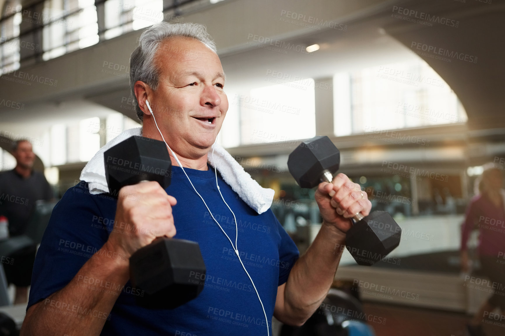 Buy stock photo Mature, happy man and weightlifting with dumbbells for fitness, workout or indoor exercise at gym. Male person with smile or earphones for strength training, muscle gain or music at health club