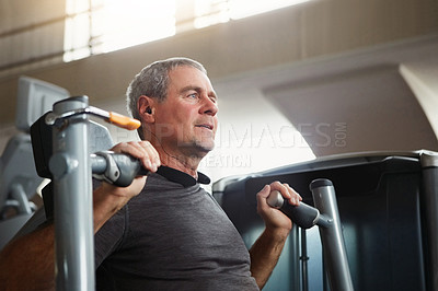 Buy stock photo Shot of a senior man working out at the gym