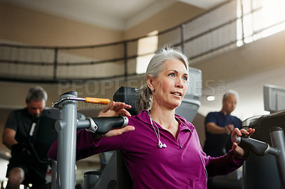 Buy stock photo Portrait of a senior woman working out with a chest press at the gym