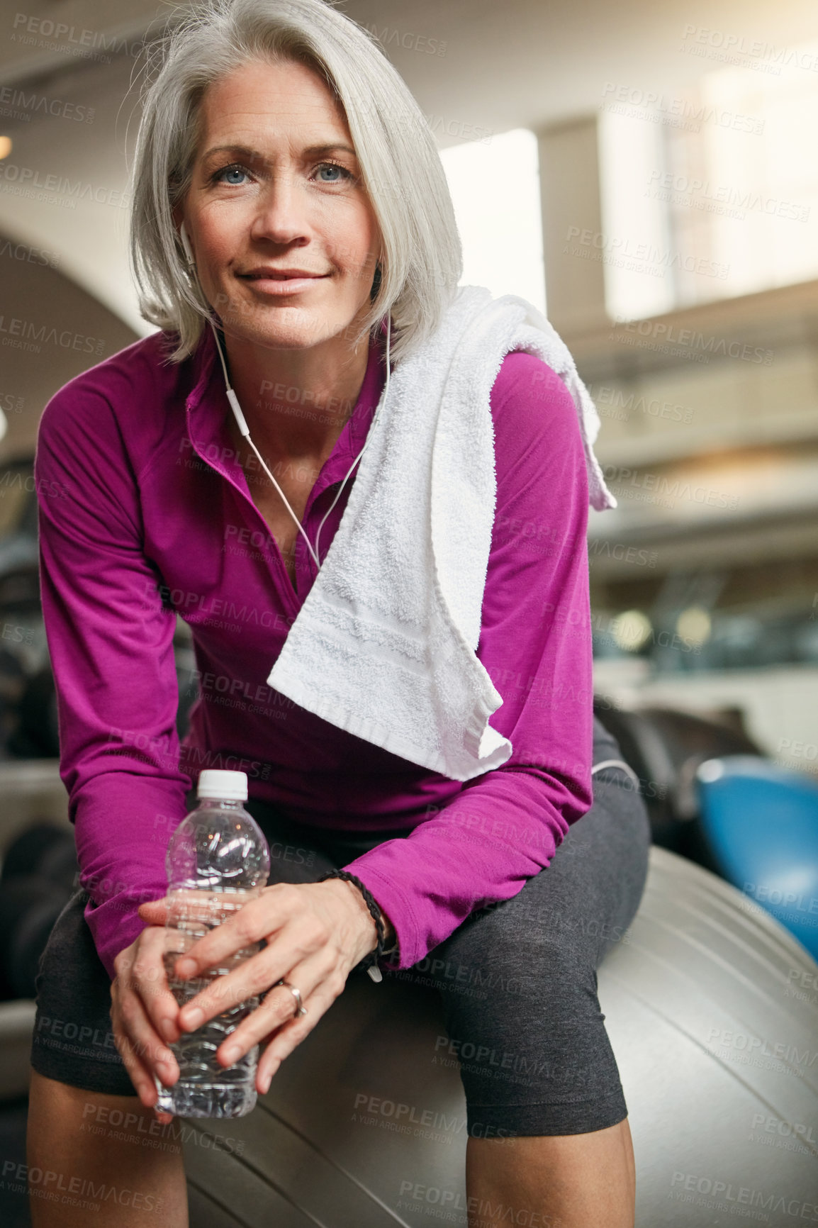 Buy stock photo Relax, portrait of mature happy woman with gym ball, fitness and pride with water bottle at workout. Exercise, training and confident female athlete on break with smile, health and wellness in club.