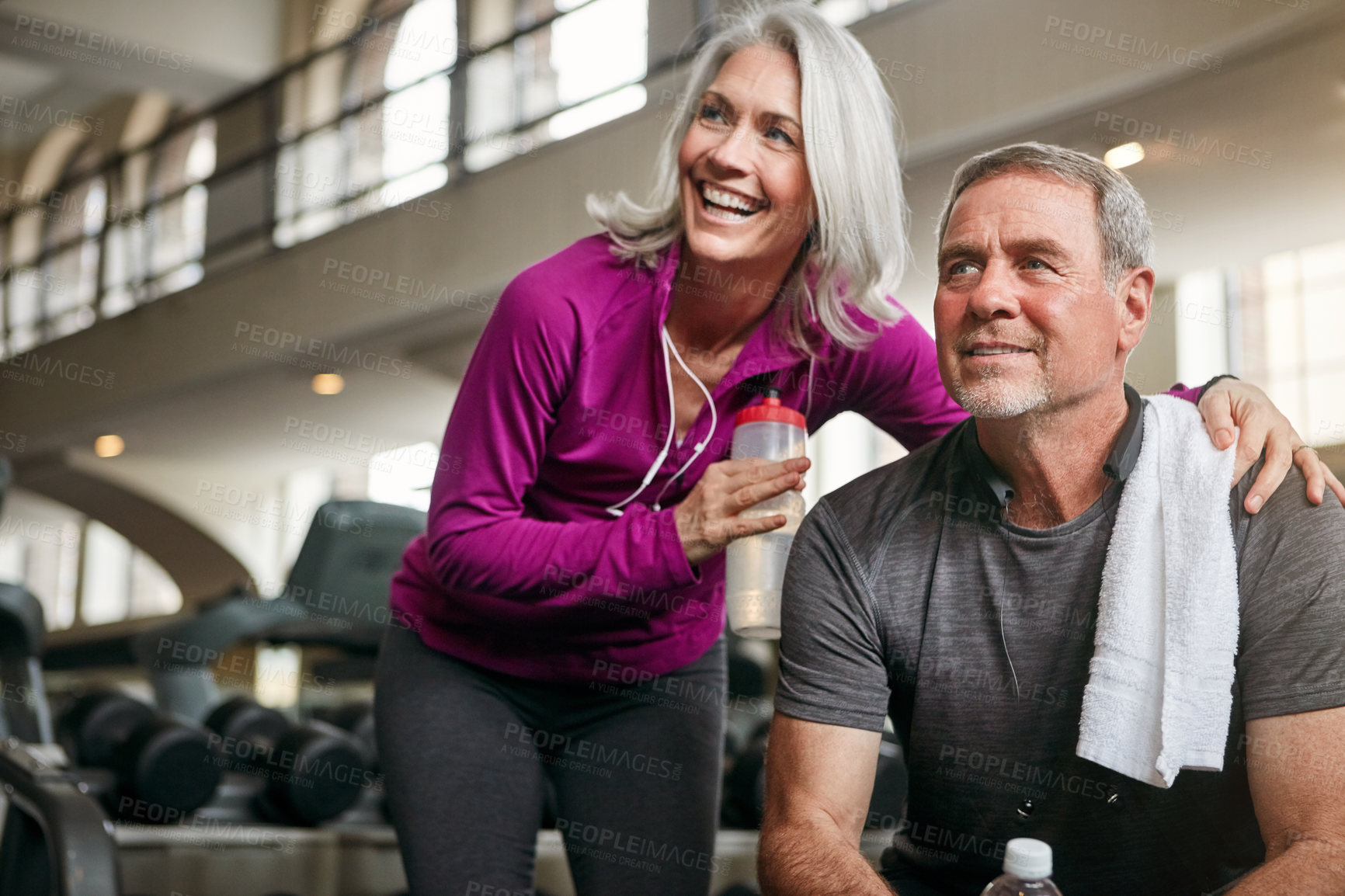 Buy stock photo Shot of a mature couple working out together at the gym