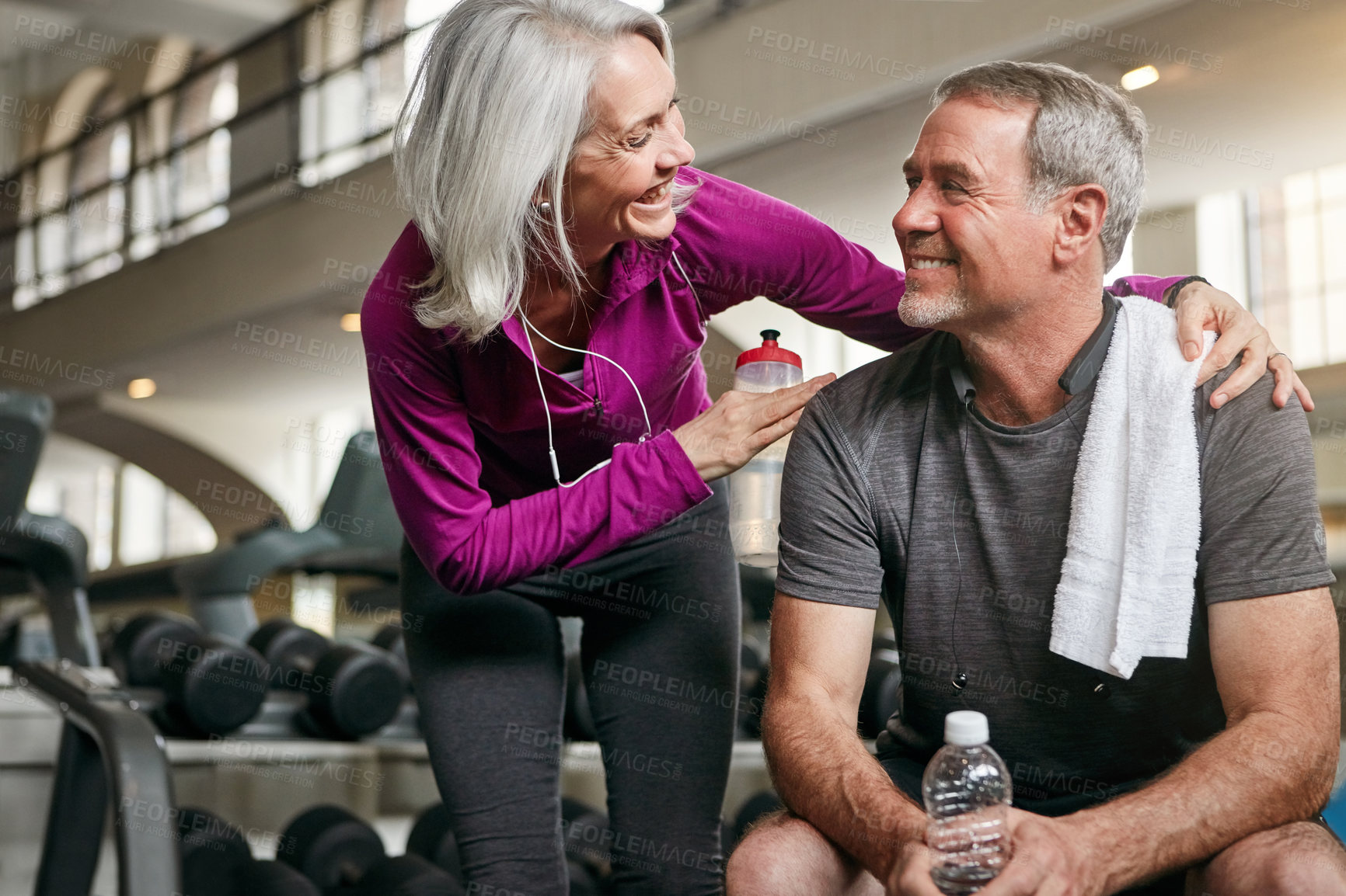 Buy stock photo Shot of a mature couple working out together at the gym