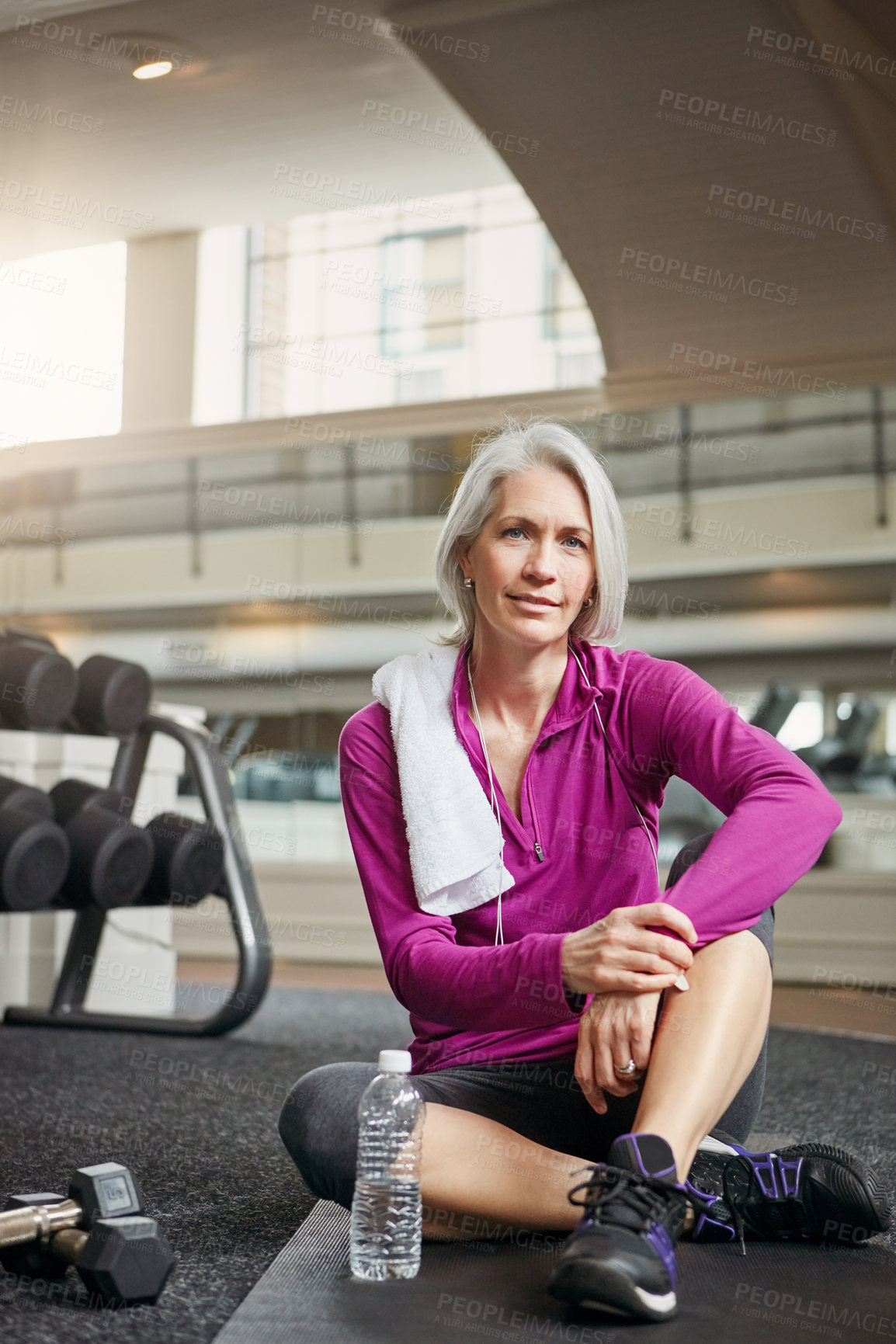 Buy stock photo Gym, portrait and mature woman with confidence, relax and dumbbells with water bottle at workout. Exercise, training and confident female athlete on break for fitness, health and wellness in club