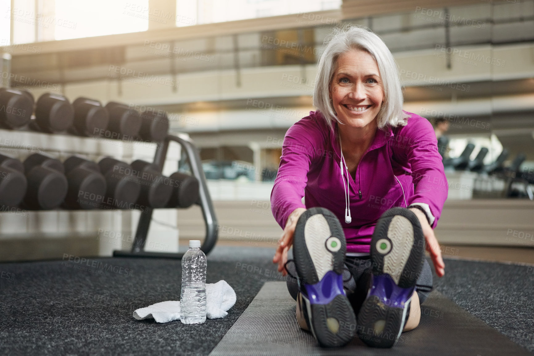 Buy stock photo Mature woman, warm up and legs on floor, stretching and smile in portrait for workout in gym. Person, muscle and start training for wellness with development, ready and exercise mat at fitness club