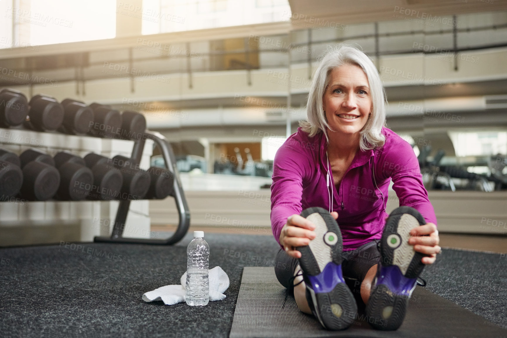 Buy stock photo Mature woman, stretching and legs on gym floor, warm up and challenge with vision for workout. Person, muscle and start training for wellness with development, ready and exercise mat at fitness club