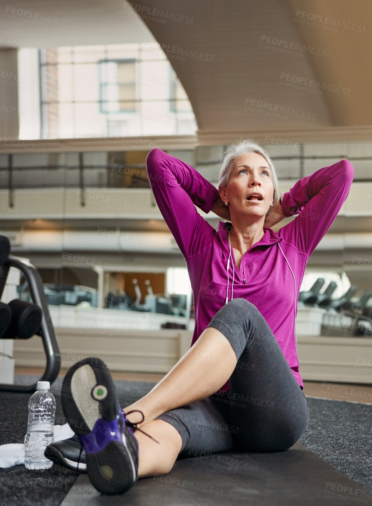 Buy stock photo Shot of a mature woman working out at the gym