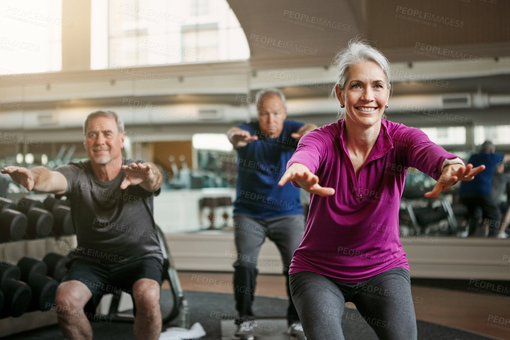 Buy stock photo Shot of a senior group of woman and men working out together at the gym