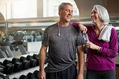 Buy stock photo Mature couple, talking and bottle in gym, smile and funny memory with training, conversation or exercise. Man, woman and happy together for fitness, workout and motivation with water at wellness club