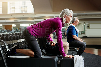 Buy stock photo Shot of a senior group of people working out together at the gym