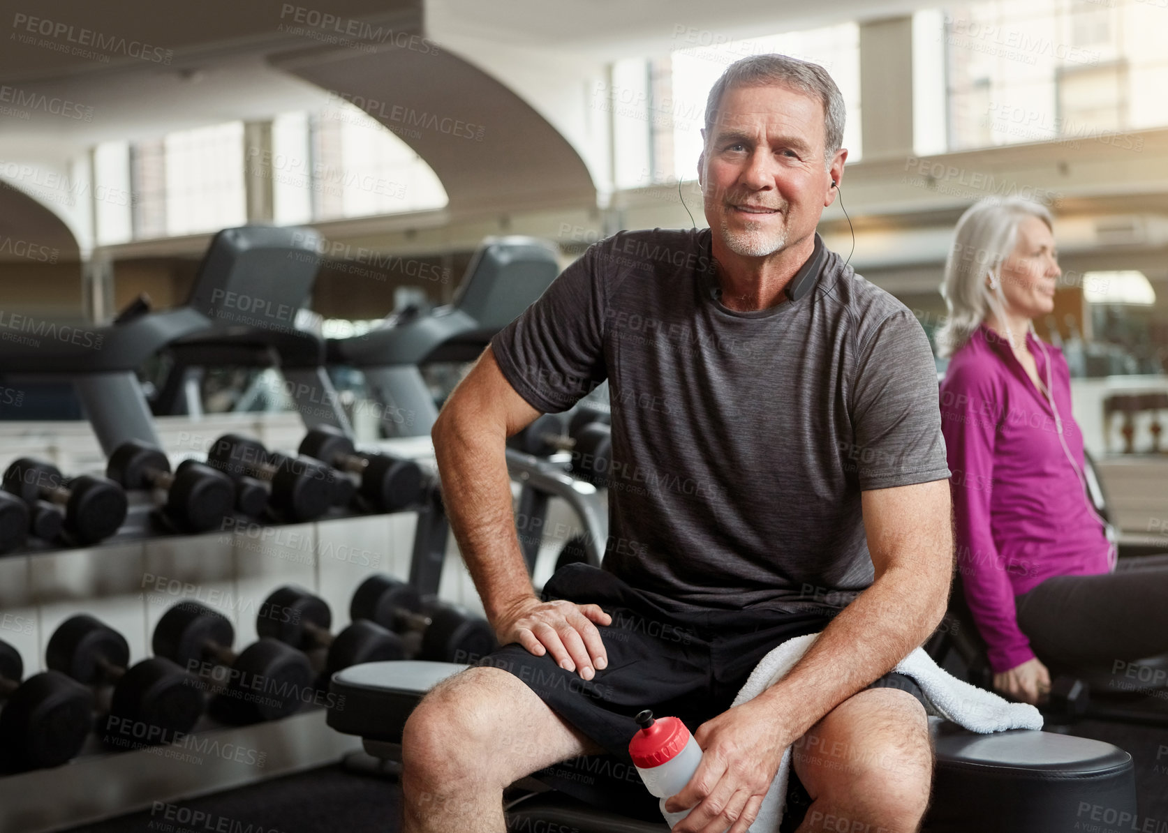 Buy stock photo Fitness, gym and portrait of old man relax with water bottle for training, exercise and workout. Sports, retirement and person listening to music, audio and podcast for wellness, health and resting