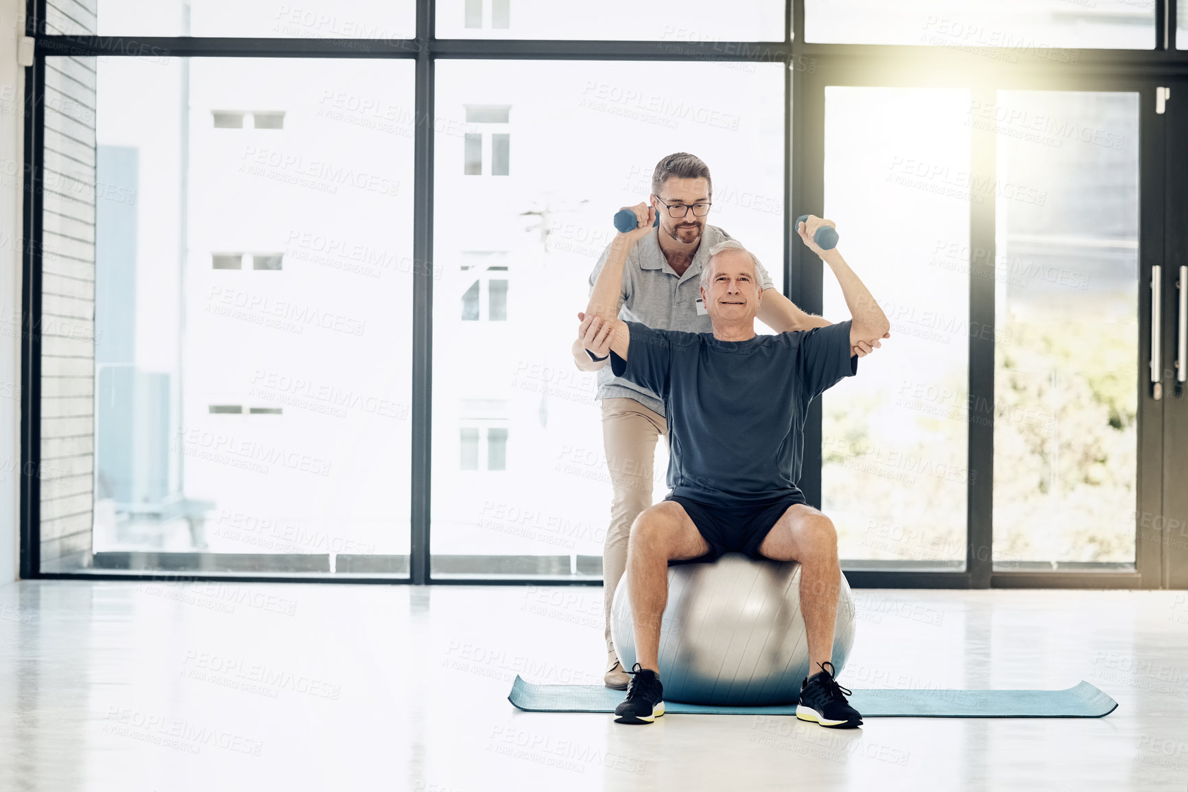 Buy stock photo Help, physiotherapy and old man with dumbbells, gym ball and rehabilitation in senior care. Physiotherapist, consultant and elderly patient in mobility training, exercise and healthcare in retirement