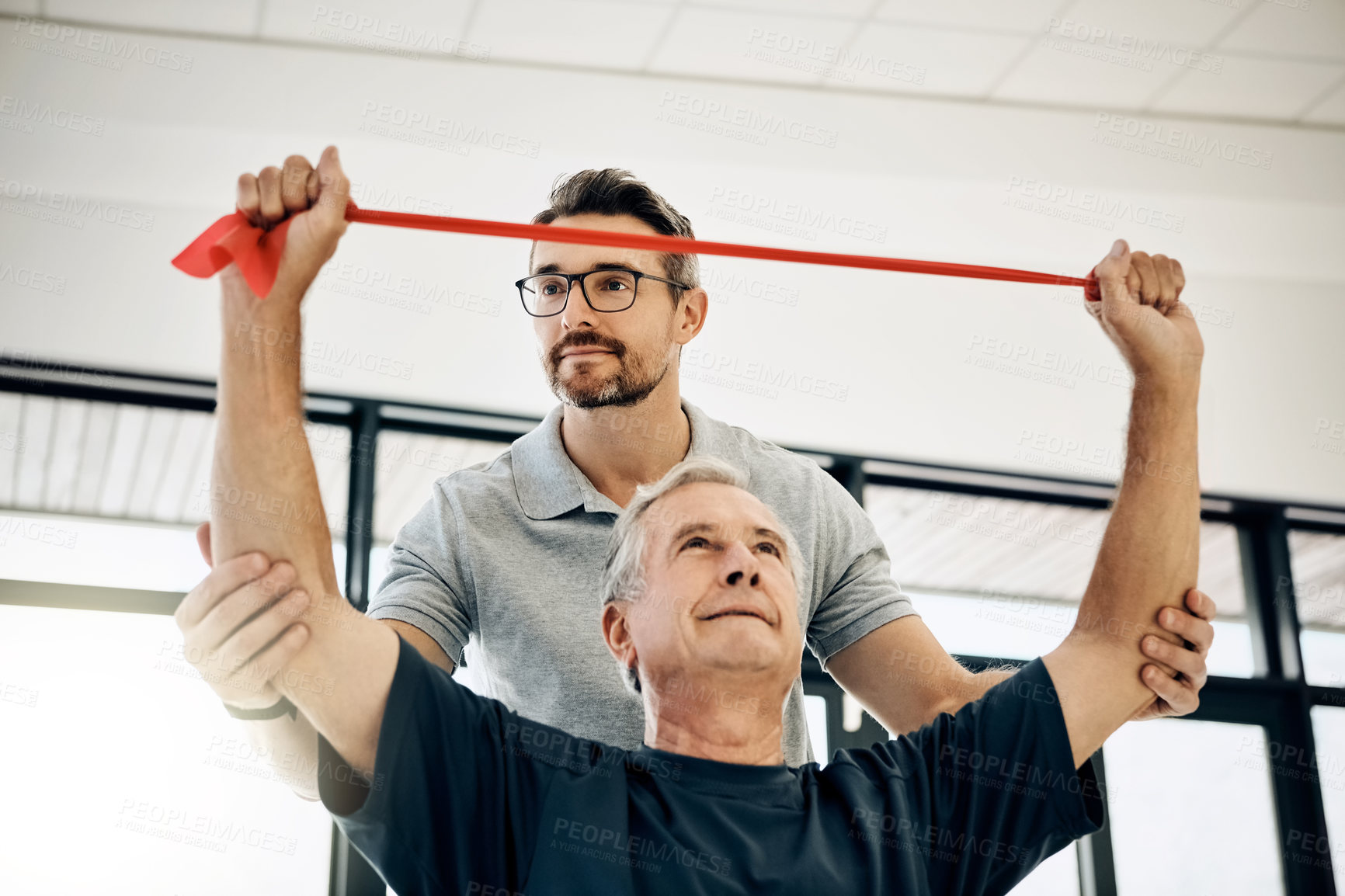 Buy stock photo Help, physiotherapy and old man with resistance band, stretching and senior care rehabilitation. Physio, caregiver and elderly patient for mobility training, exercise and healthcare in retirement.