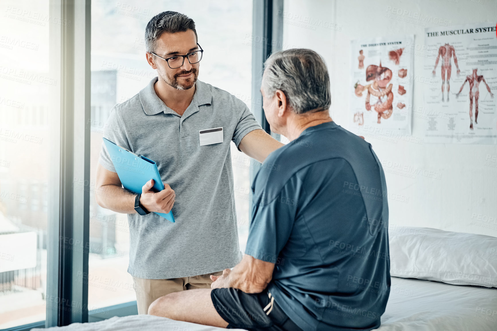 Buy stock photo Shot of a caring physiotherapist consulting with his mature patient in the rehabilitation center