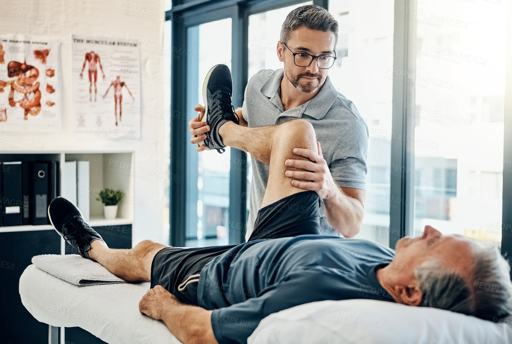 Buy stock photo Stretching legs, rehabilitation and a physiotherapist with a man for wellness and disability support. Help, health and a male doctor helping an elderly person with physiotherapy on body muscle