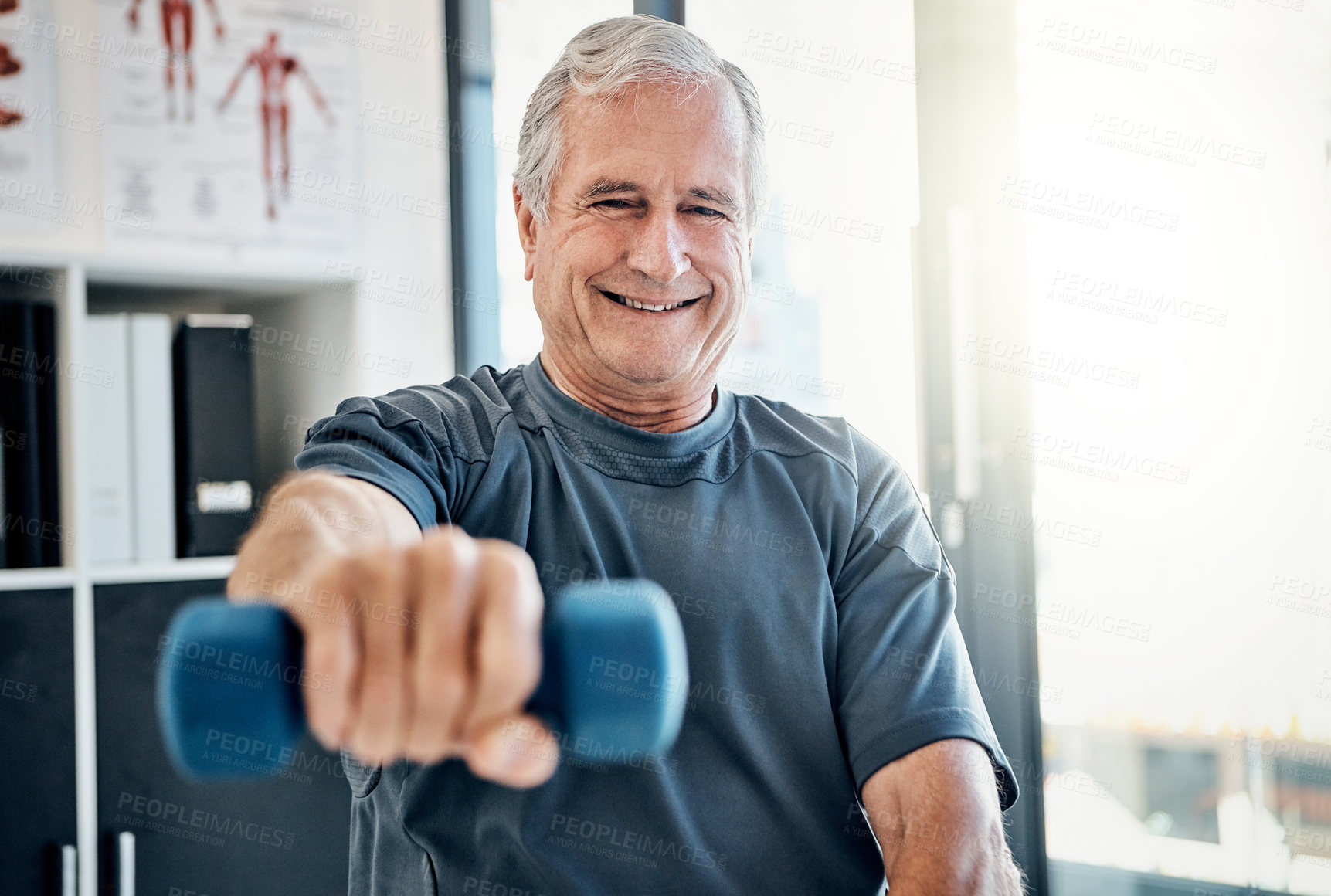 Buy stock photo Shot of an elderly man working out with weights at a rehabilitation center