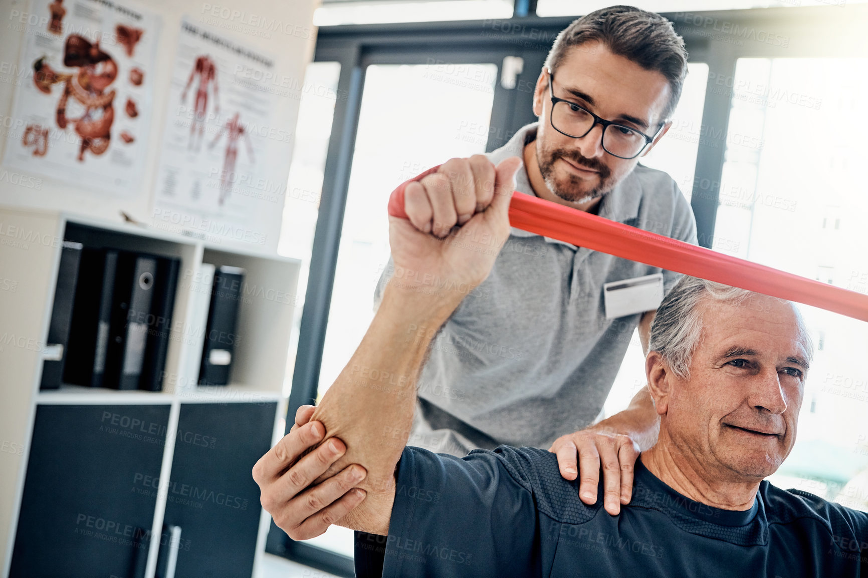 Buy stock photo Stretching, physiotherapy and old man with resistance band, support and clinic for senior healthcare. Physio, therapist and elderly patient for mobility training, exercise and help in retirement.